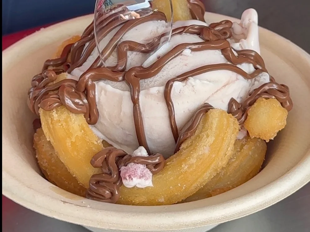 Churros with a scoop of ice cream and caramel drizzle